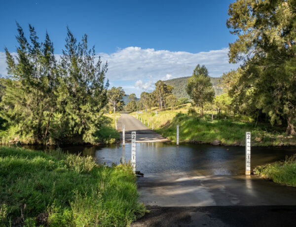 A 4WD track leading through a river crossing on the Condamine River Road in the Scenic Rim, Queensland.